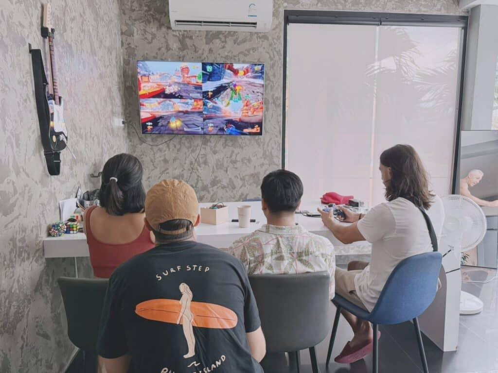 Fellow travelers relaxing and playing video games in the lounge at Tall Tree Kata