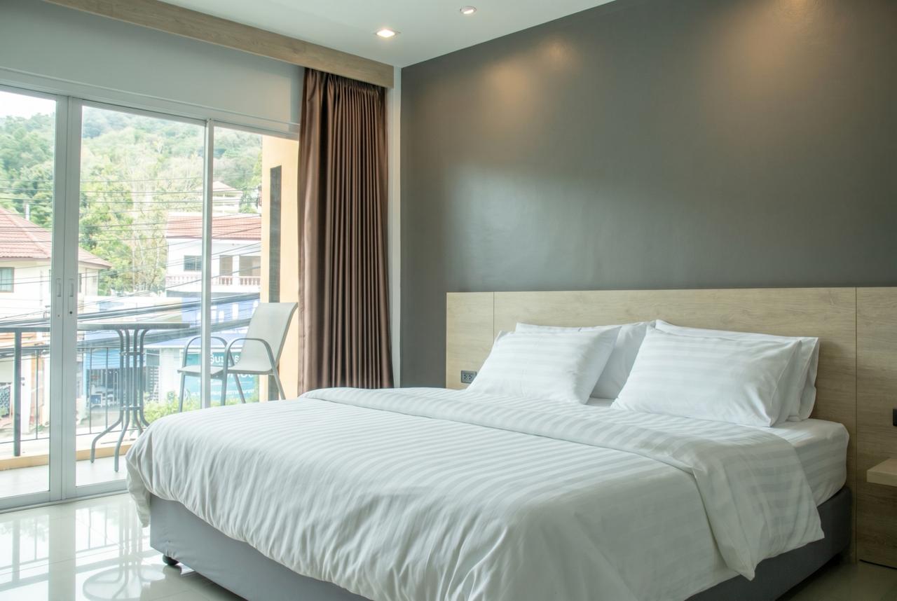 A private double bedroom with a balcony at Tall Tree Kata